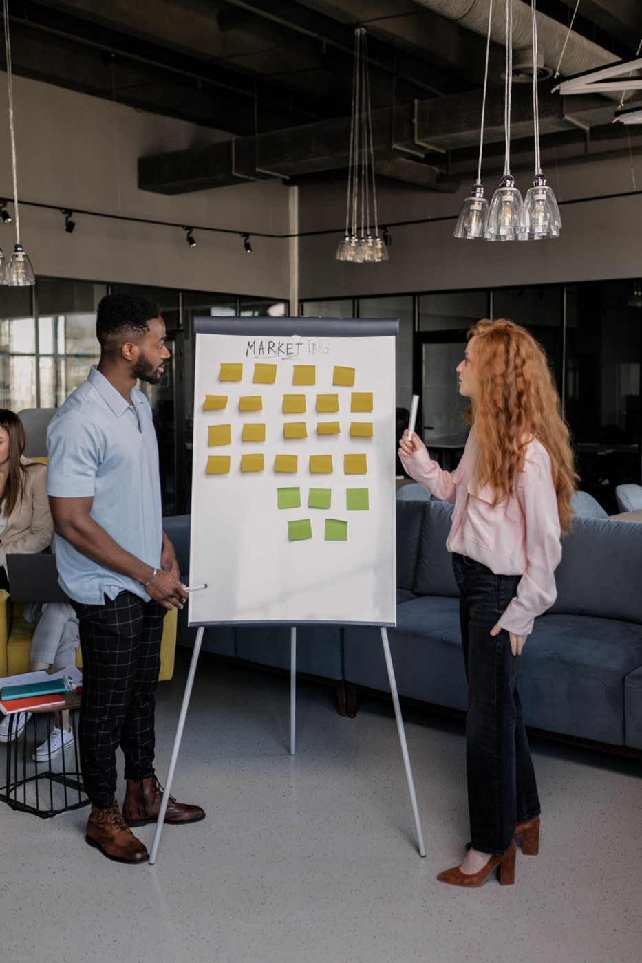 Colleagues planning ideas at a whiteboard